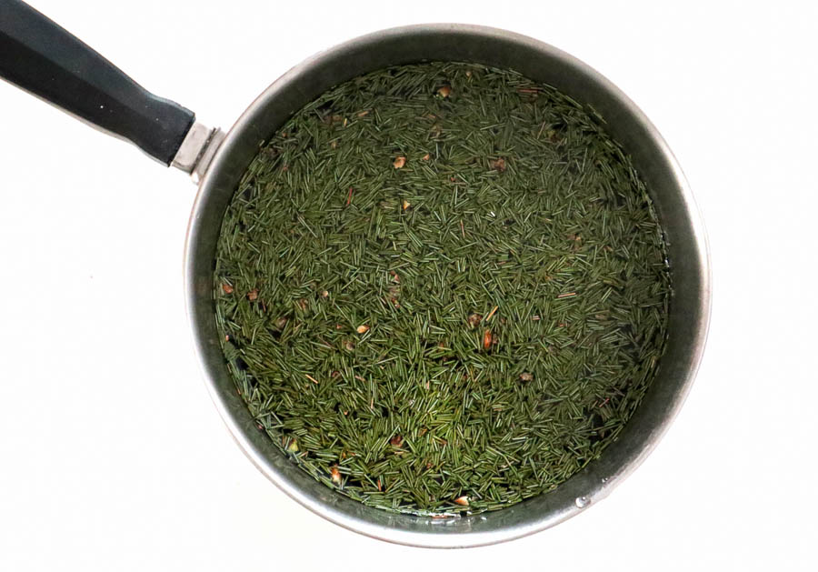 Pink pine needle tea brewing on the stove.